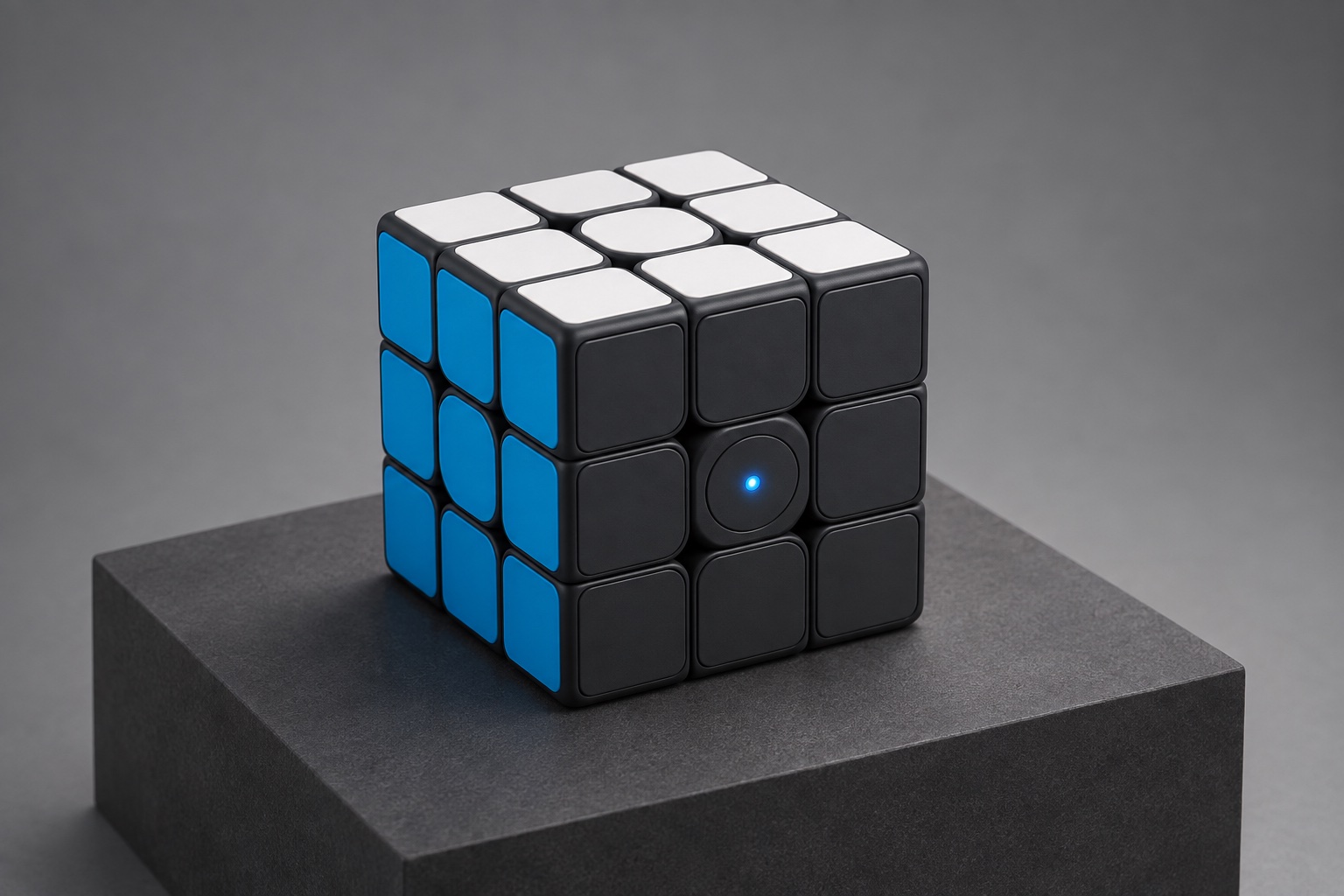 Studio concept visualization of a graphite, white, and blue educational cube on a charcoal display plinth